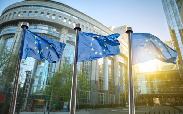 European union flag against parliament in Brussels, Belgium