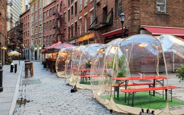 Outdoor dining tables in bubbles along Stone Street during the coronavirus pandemic in downtown Manhattan, New York City NYC