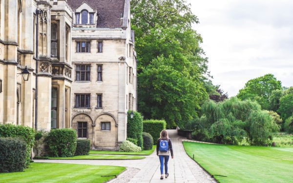 A female student walks into halls at the University of Cambridge