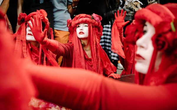 Extinction Rebellion's "red brigade" outside London Fashion Week to raise awareness on the climate impact of fashion.