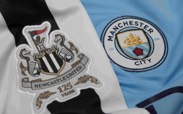 Newcastle united football shirt next to a Manchester city shirt