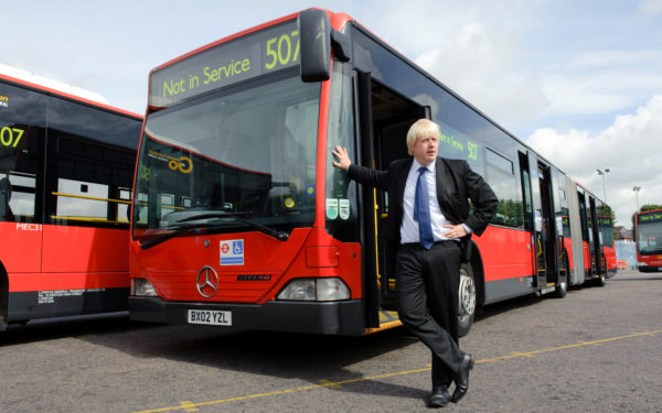 Boris Johnson leans on an out of service bus