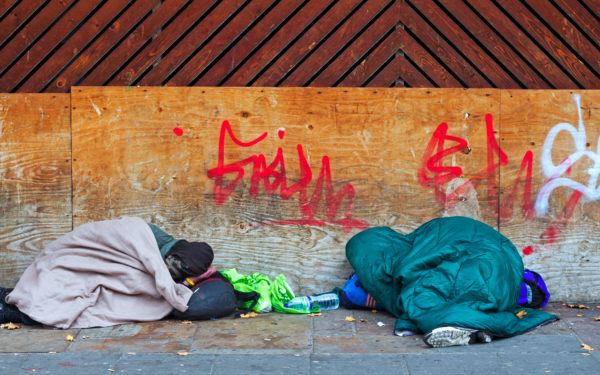 Two homeless people sleeping out on the streets of Liverpool UK - UK homelessness