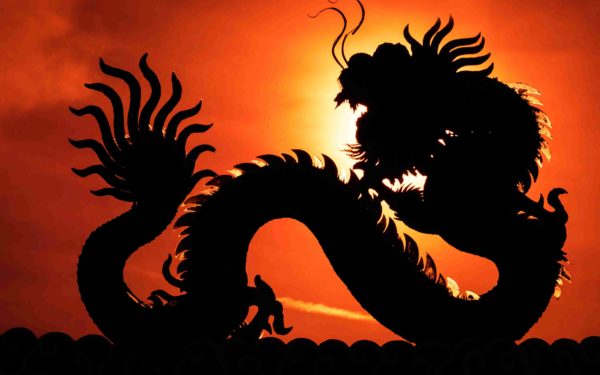 A silhouette image of Chinese dragon statue