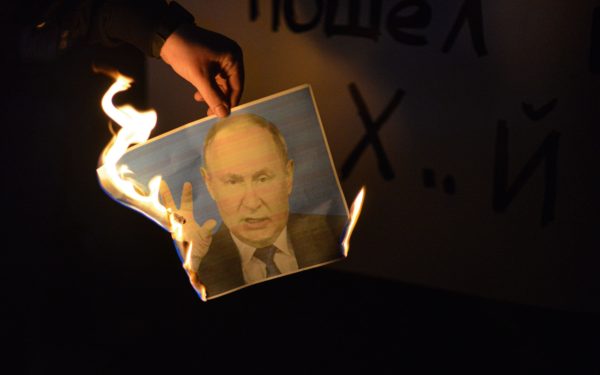 Protestor burns a photo of Putin during a protest of Israeli Ukraine supporters demonstrate against the Russian invasion. Tel Aviv, Israel. Feb 26th 2022. (Photo by Matan Golan/Sipa USA), meta