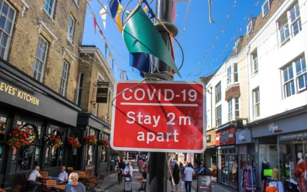 Worthing / UK - 14 September 2020: 'COVID-19; stay 2m apart' sign in Worthing Town Centre, West Sussex, England