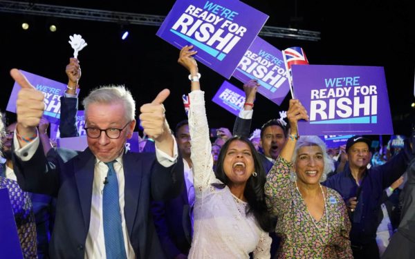 Michael Gove (left), Rishi Sunak's wife Akshata Murthy (centre) and mother Usha Sunak (right) cheer Rishi Sunak during a hustings event at Wembley Arena, London, as part of the campaign to be leader of the Conservative Party and the next prime minister. P