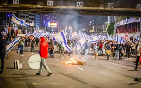 Tel Aviv, Israel. 25th Mar, 2023. Protesters wave Israeli flags during the demonstration.