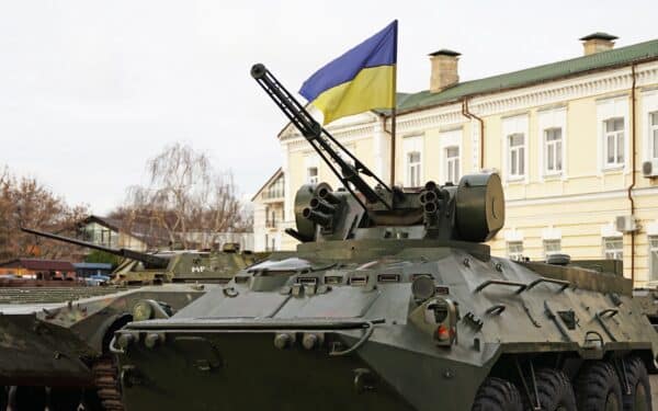 Army troops transporter and tank with Ukrainian flag, Ukraine