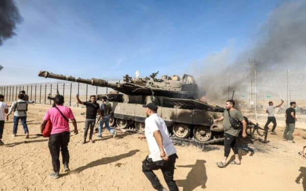 Palestinians take control of an Israeli tank after crossing the border fence with Israel from Khan Yunis. 7th October 2023. (via dpa picture alliance / Alamy) following surprise Hamas attack
