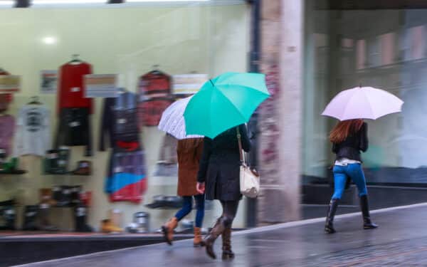 Rainy street of shoppers, amid UK entering recession