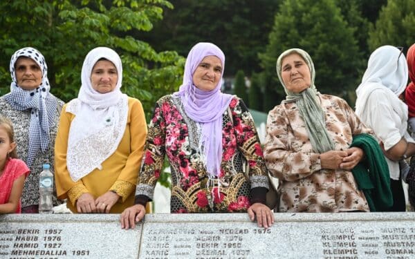 Bosnian women visit Srebrenica Genocide Memorial (via Ajdin Kamber/ Shutterstock)