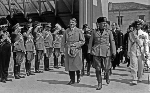 Adolf Hitler and Benito Mussolini walking in front of saluting military during Hitler's visit to Venice, Italy, 1934. (via US Library of Congress/ wikimedia)