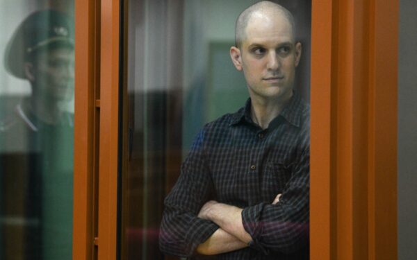 Wall Street Journal reporter Evan Gershkovich stands in a glass cage in a courtroom in Yekaterinburg, Russia,