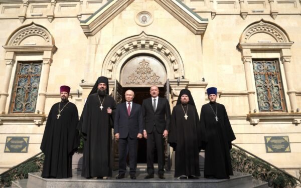 The Bishop of Baku and Azerbaijan Aleksiy Smirnov, 2nd left, stands for a group photo with Russian President Vladimir Putin, and Azerbaijani President Ilham Aliyev, during a visit to the Holy Myrrhbearers Cathedral, August 19, 2024 in Baku, Azerbaijan.