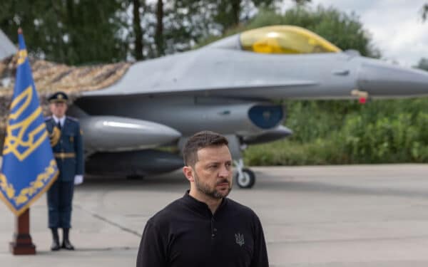 Ukraine, August 04 2024. Ukraine's President Volodymyr Zelenskyy talks on the occasion of the Air Forces Day standing against the background of Ukraine's Air Force's F-16 fighter jets.