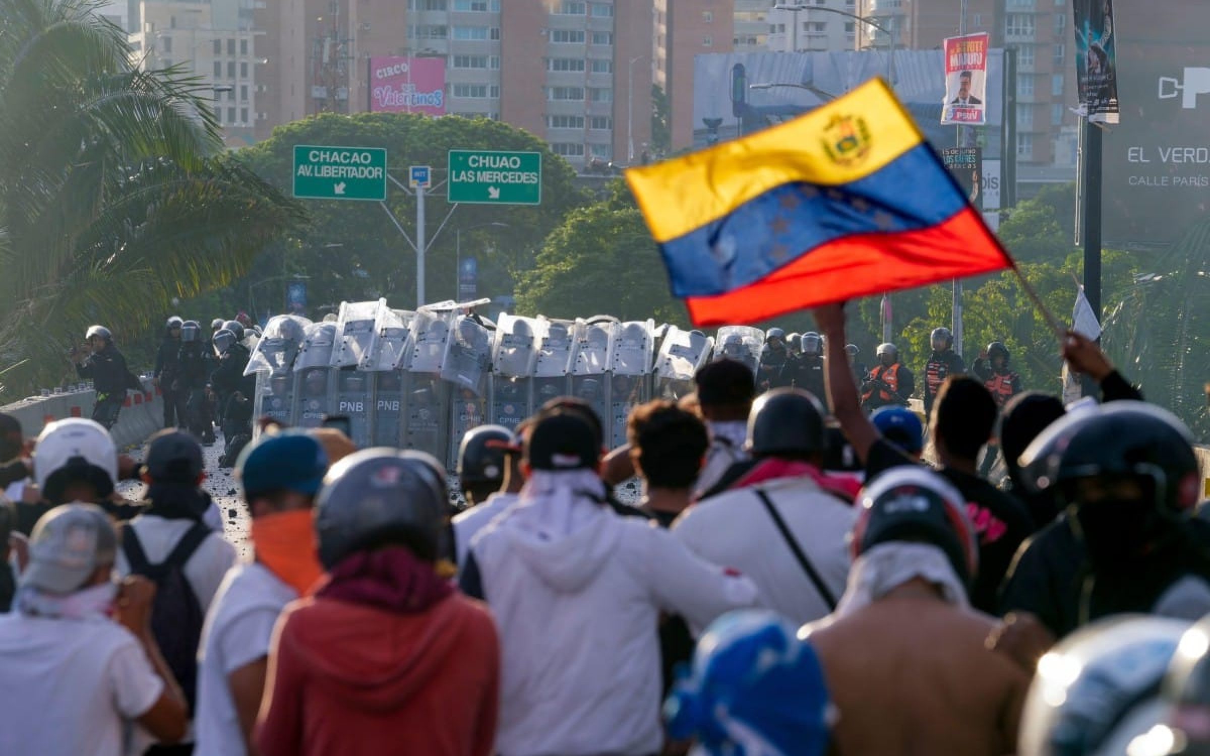 Police block protesters during demonstrations against the official election results declaring President Nicolas Maduro's reelection, the day after the vote at a highway in Caracas, Venezuela