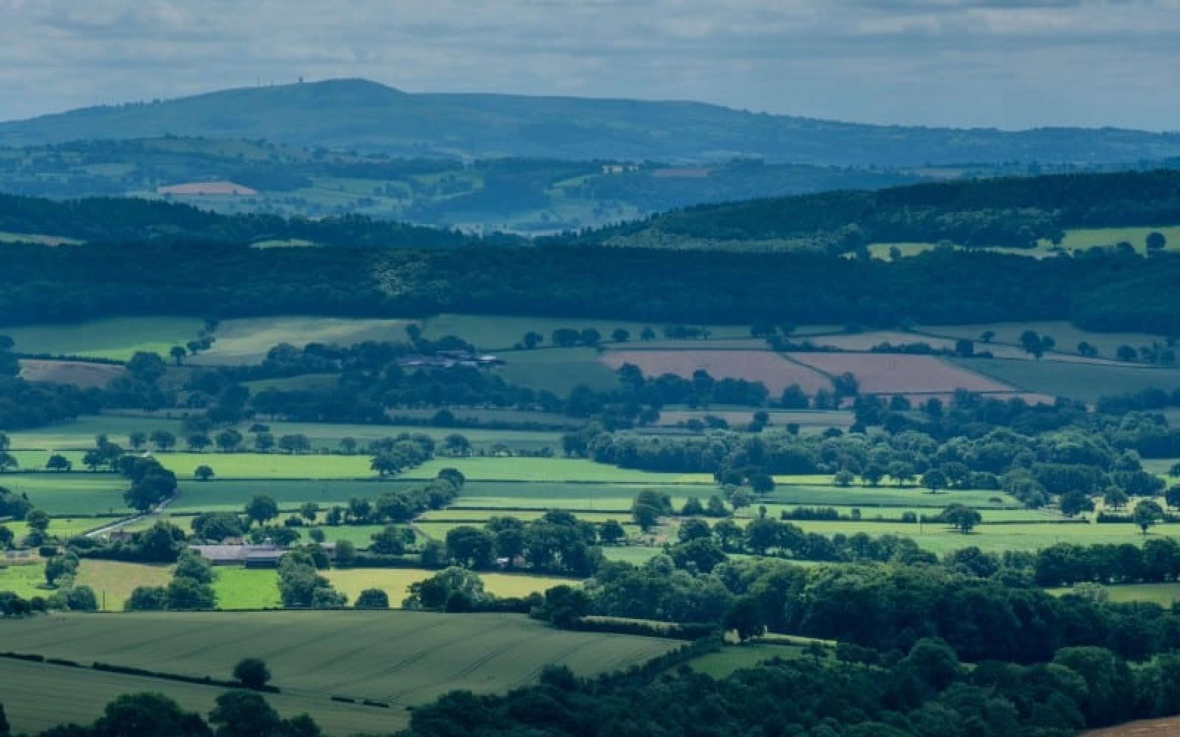 Titterstone Clee Hill, part of Wenlock Edge, and Ape Dale seen from Ragleth Hill, Church Stretton, Shropshire, England, UK