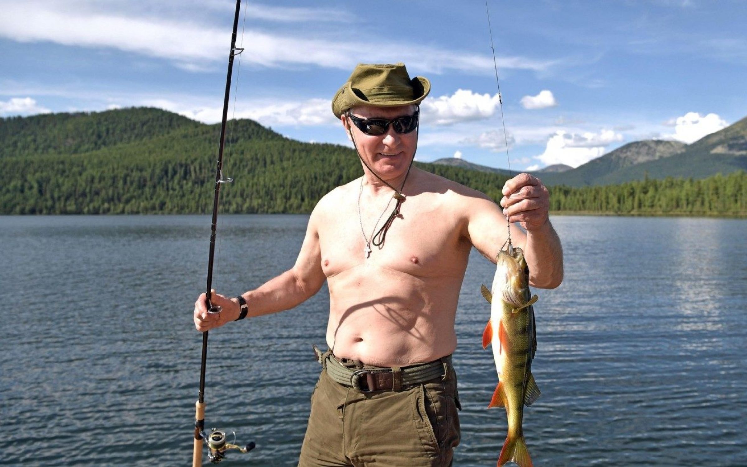Russian President Vladimir Putin holds a fish he caught fishing during a three-day fishing and hunting trip in the Siberian wilderness near the Mongolian border August 1-3, 2017 in the Tyva Republic, Russia.