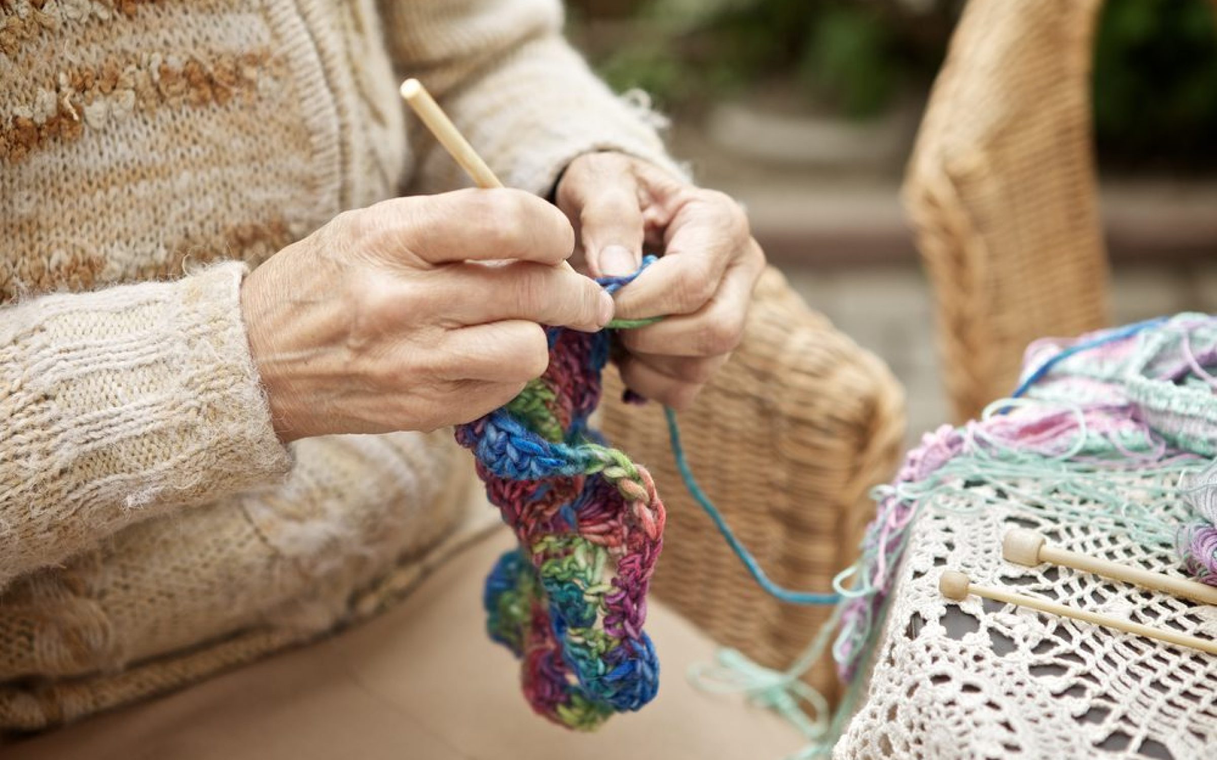 Hands of elderly woman knitting in care home