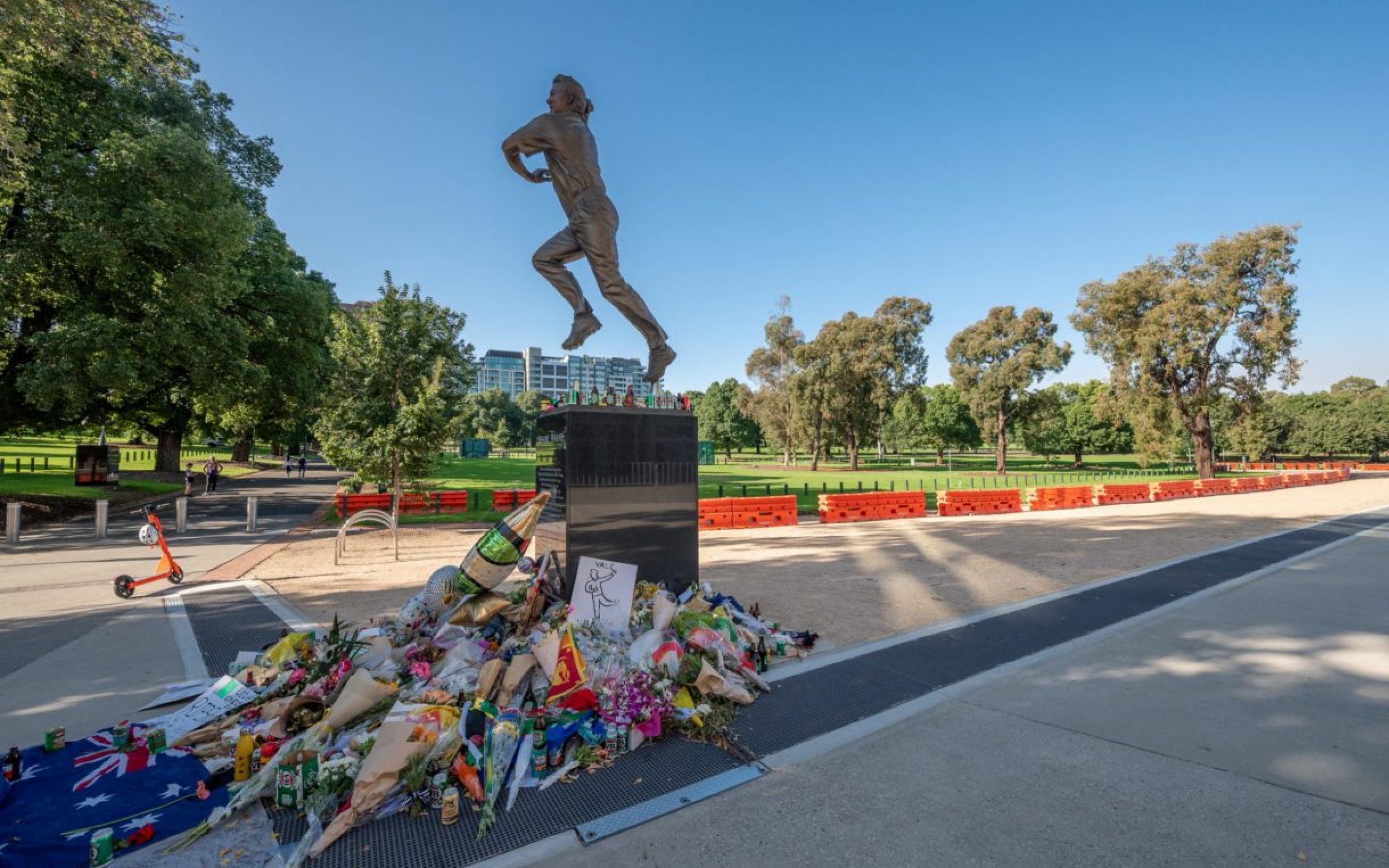 Melbourne, Victoria, Australia - March, 2022: Memorial tributes to the great Australian leg-spin bowler Shane Warne at the base of his bronze statue outside the Melbourne Cricket Ground.