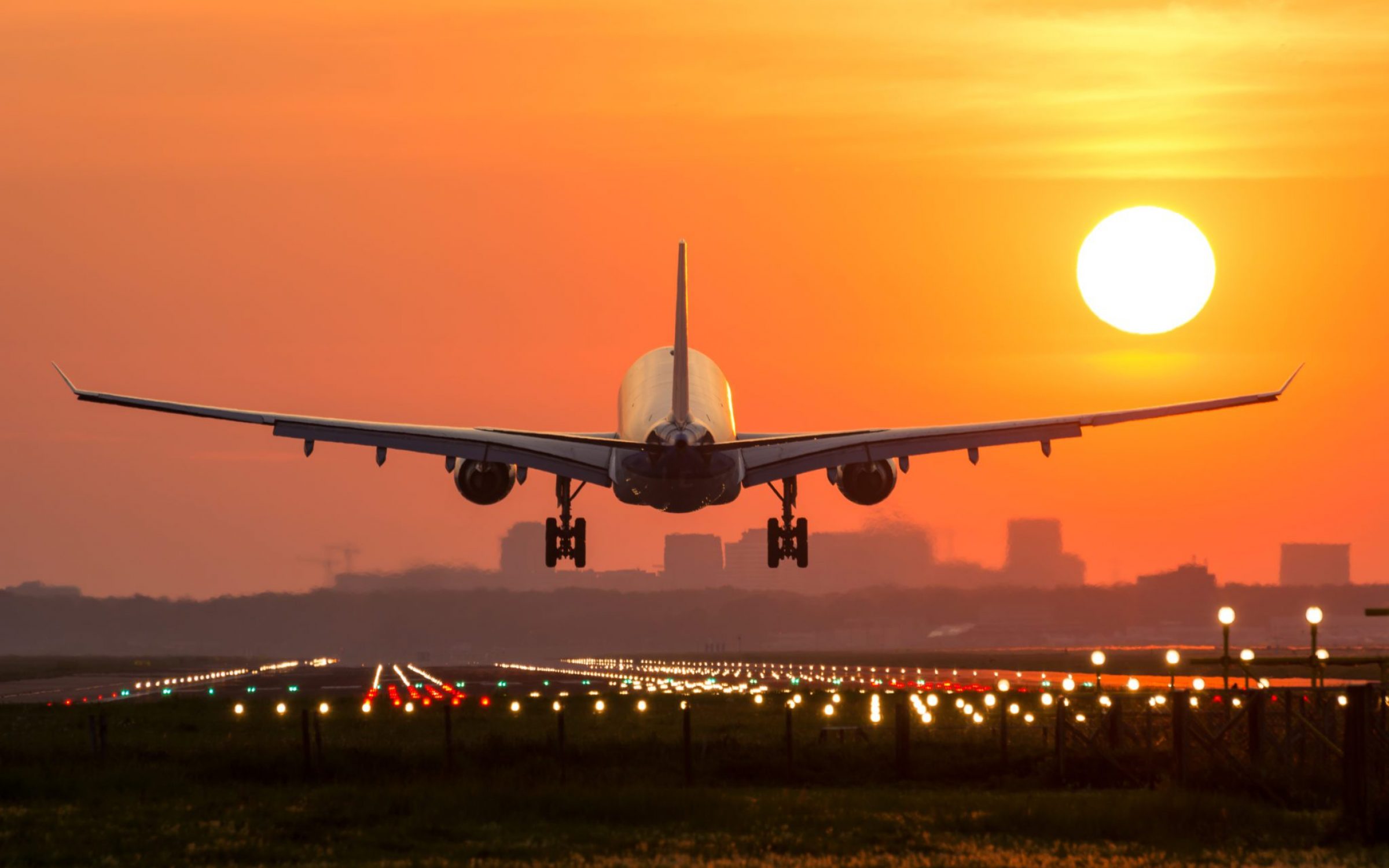 Passenger plane lands during a wonderful sunrise.