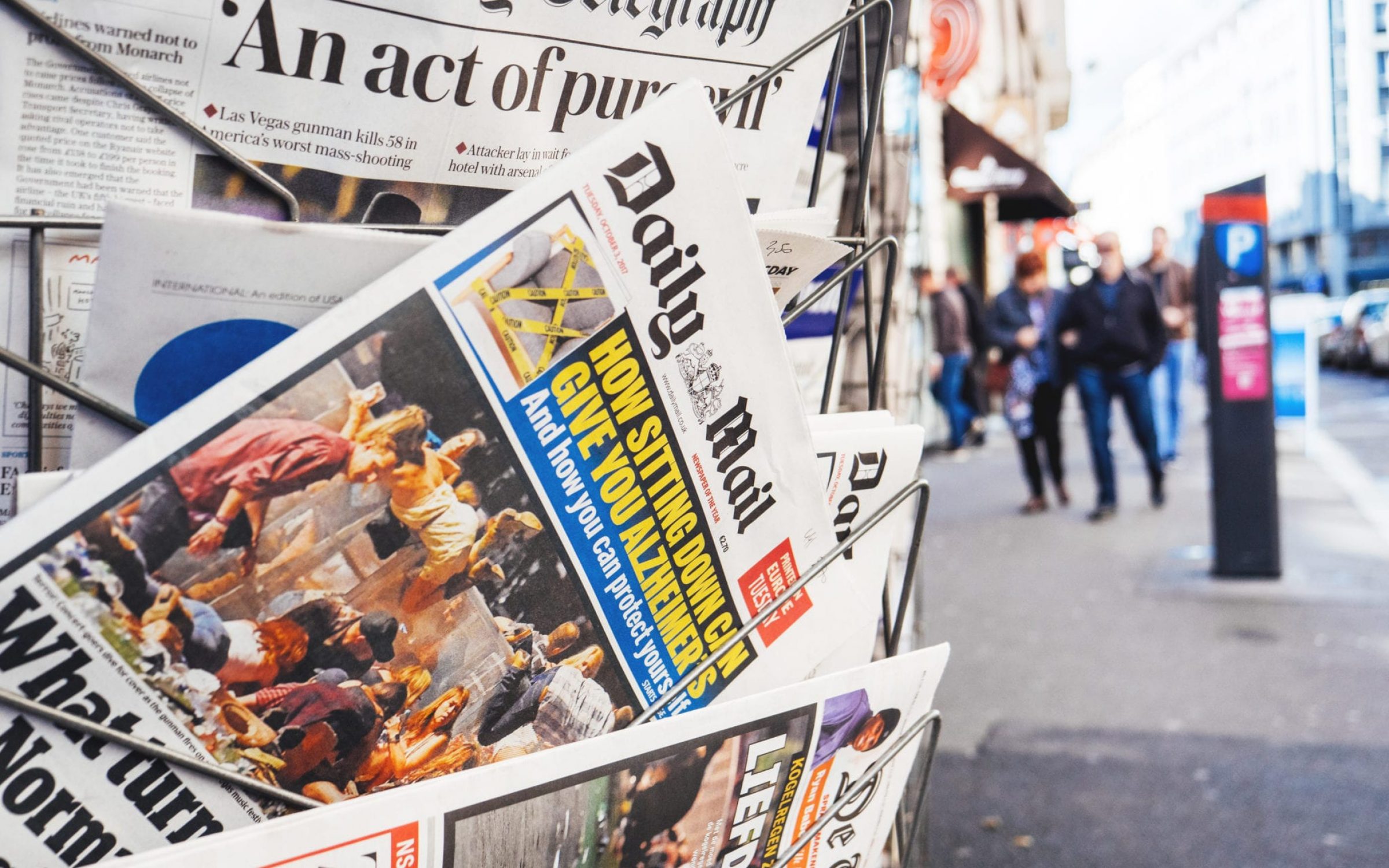 A newspaper stand with a copy of the Daily Mail poking out