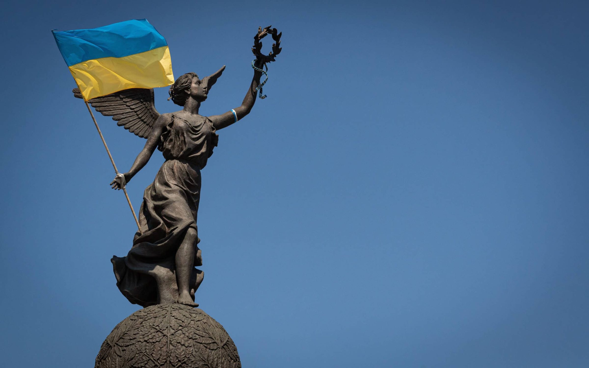 Ukrainian flag and statue in the city of Kharkiv, Ukraine.